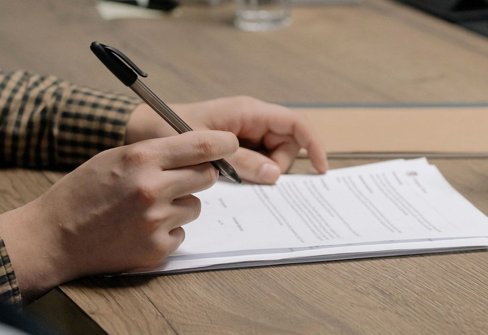 Hands resting together at a kitchen table